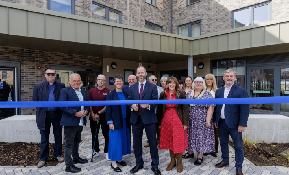 Partners and community representatives cut a ribbon in front of the recently completed Birch Lea Park development to mark its official opening